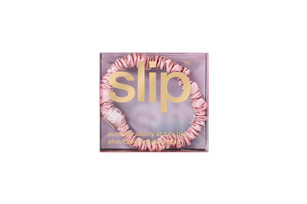 Pink skinny silk scrunchie in a box with 'slip' branding on a white background