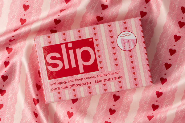 Pink 'slip' pillowcase with heart pattern on a matching fabric background