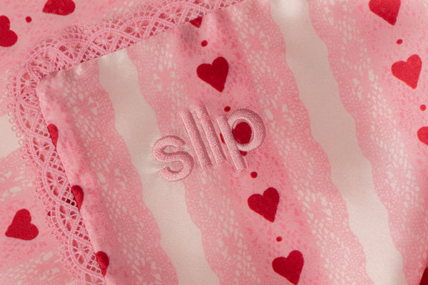 Pink slip with red heart patterns and lace trim