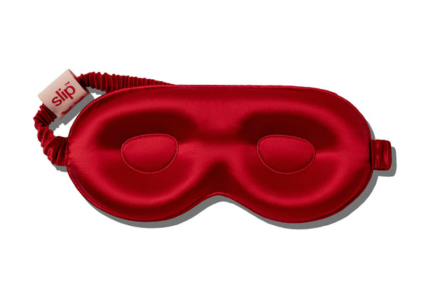 Red silk contour sleep mask with 'slip' label on a white background