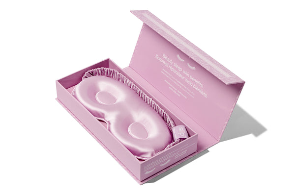 A purple slip silk contour sleep mask , designed for eyelash extension wearers. Displayed in open branded packaging on a white background.