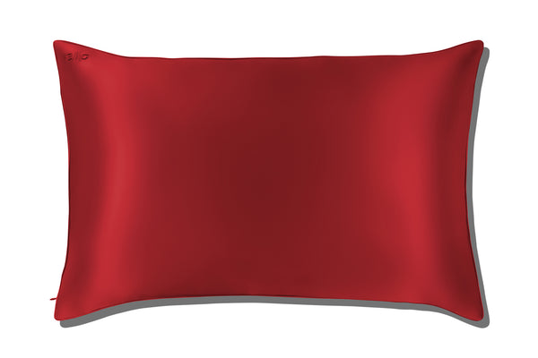 Red silk pillowcase on a white background
