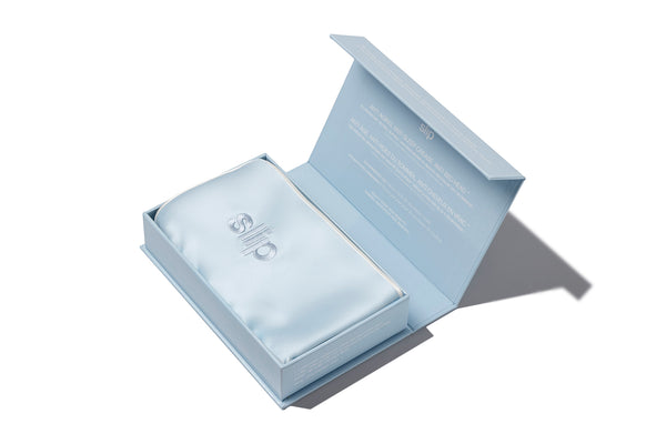A seabreeze blue slip silk queen pillowcase with an invisible zipper closure. Displayed in open slip branded packaging box on a white background.