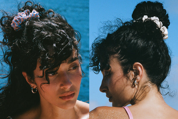 Large silk scrunchies in white and blue in a bun style on a model.