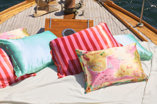 Various coloured slip silk pillowcases on a boat.