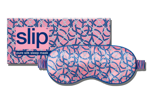 A slip pure silk sleep mask with a blue nautical ropes pattern on a pink background, with slip packaging on a white background.