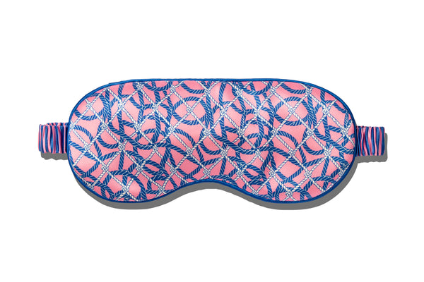 A slip pure silk sleep mask with a blue and pink nautical ropes pattern on a white background.