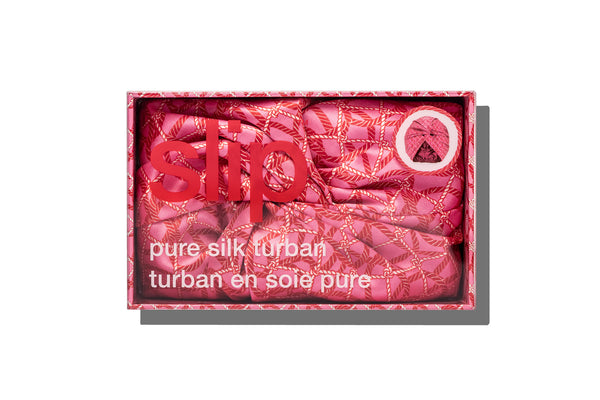 A red and pink nautical themed silk turban in slip branded packaging on a white background.