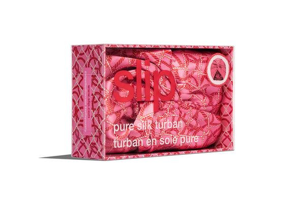 A red and pink nautical themed silk turban in slip branded packaging on a white background.