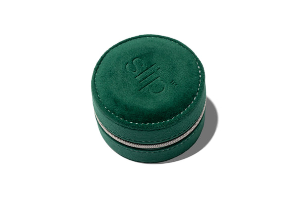 Green round suede case with zipper and slip logo embossed on a white background