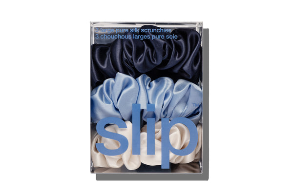 Box of slip large scrunchies in navy, blue, and white on a white background