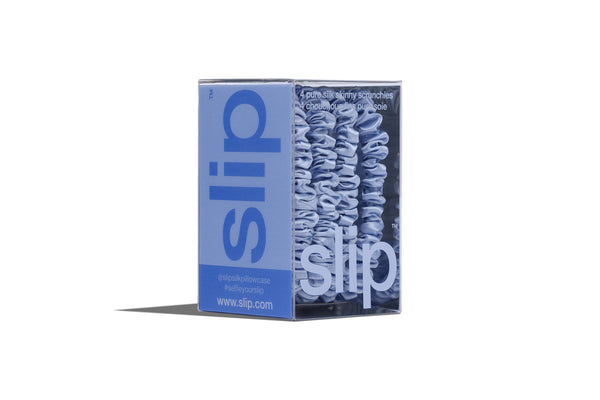 Box of blue slip scrunchies on a white background