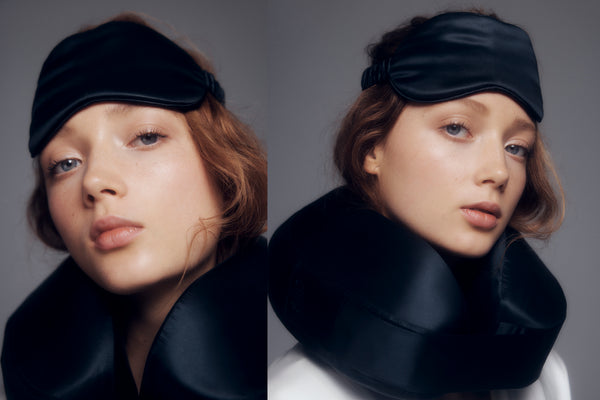 Model wearing a black silk travel pillow and a black pure silk sleep mask.