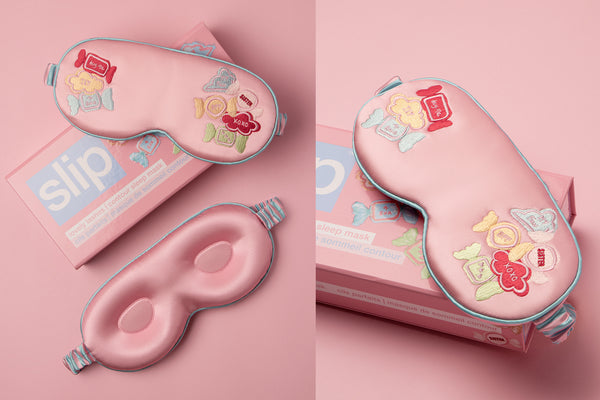 Pink sleep mask with colourful candy designs and 'slip' branding on a pink background