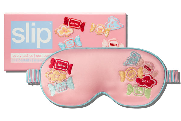 Pink sleep mask with candy-themed design and 'slip' packaging