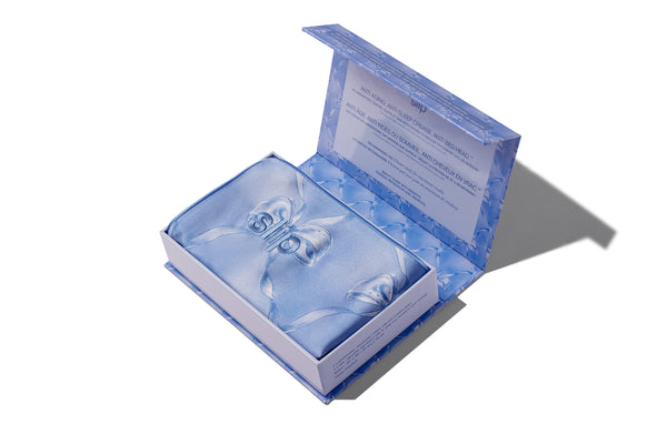 Open blue silk pillowcase box on a white background