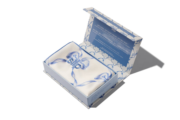 Open silk pillowcase box with a blue and white pattern on a white background