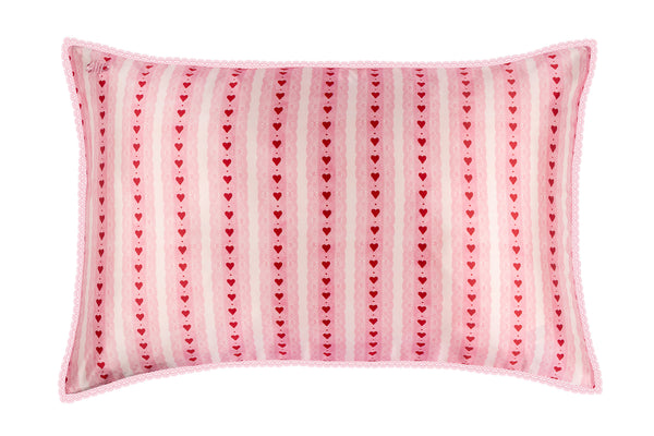 Pink pillow with heart pattern on a white background