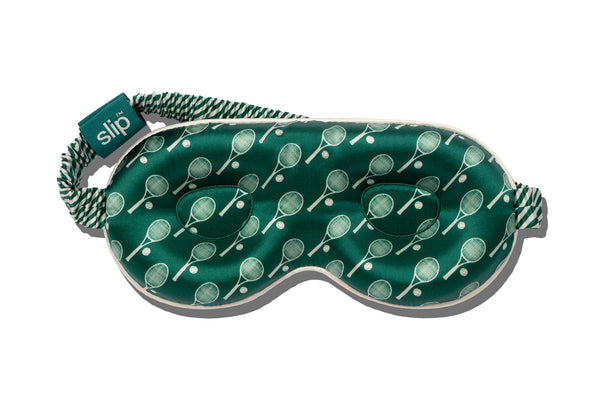 Green silk contour sleep mask with tennis racket pattern on a white background