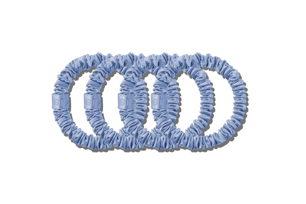 Set of blue silk hair ties on a white background