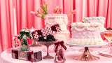 a table with pink and white cakes